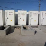 Professional installation of GreenBatt Smart ESS All-In-One commercial energy storage systems, showing multiple liquid-cooled battery cabinets with green housings deployed in an industrial facility.