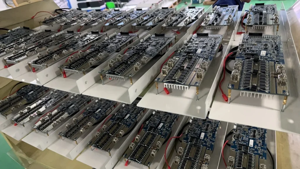 Close-up of a lithium battery management system (BMS) circuit board, showing hardware details such as precision chips, sensor interfaces, balancing resistors, and battery connection terminals.